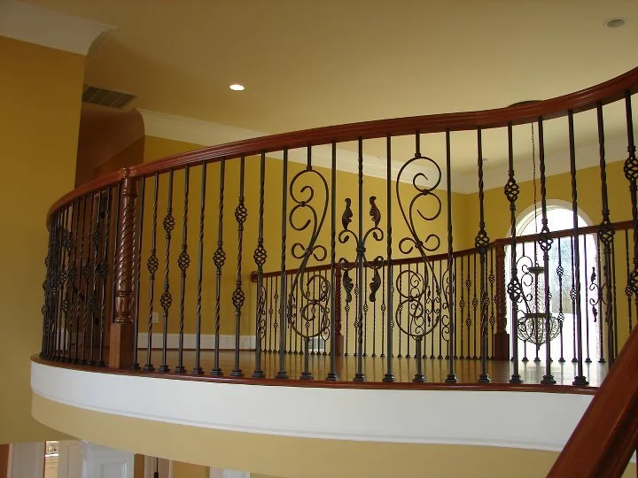 Ornate iron balusters on curved balcony rail