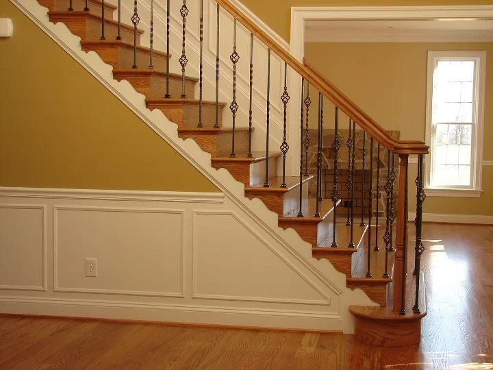 Custom newel post with iron scroll balusters