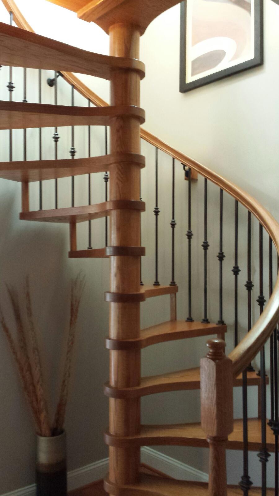 Spiral staircase with iron balusters and center pole
