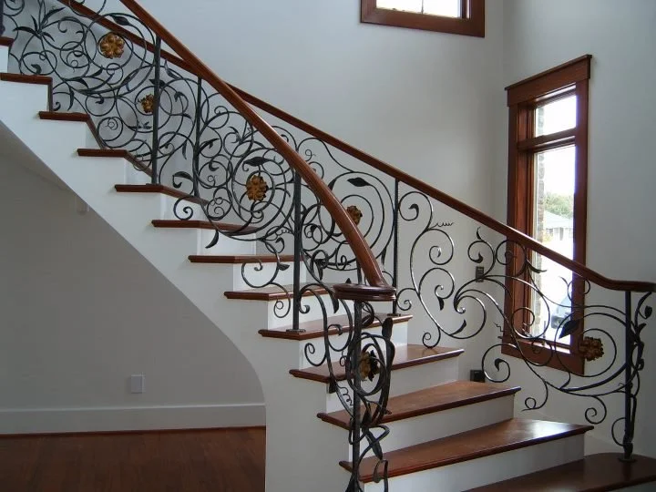 Stair system with ornate iron balusters